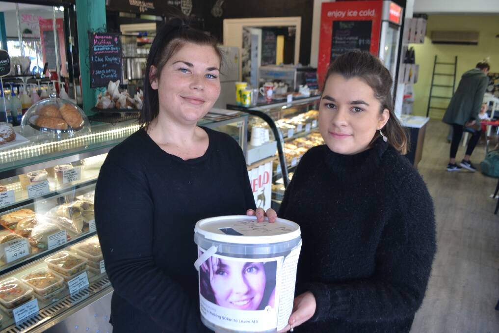 Sarah Walters and Elissa Nicholson of the Narooma Ice Creamery with a donations bucket for MS Research Austraila, honouring the late Belinda Green. 