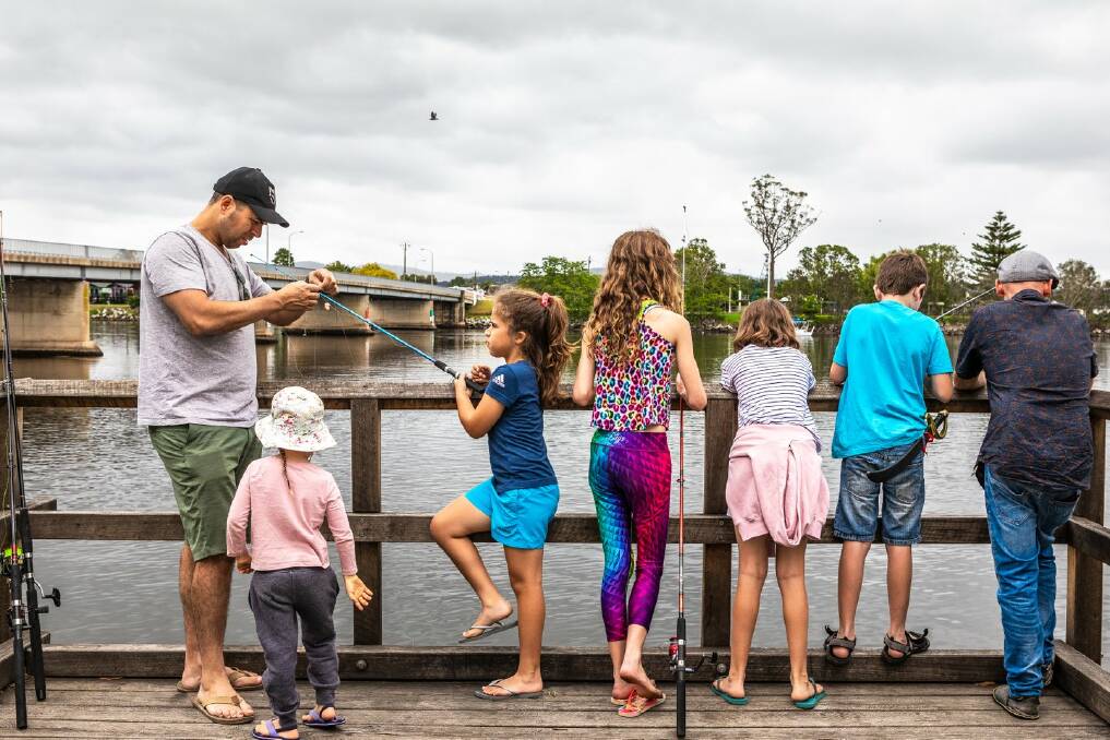 Families fishing off the Moruya Wharf. A new virtual postcard campaign has Eurobodalla residents inviting family and friends to visit and enjoy the shire's attractions. Image: Supplied. 