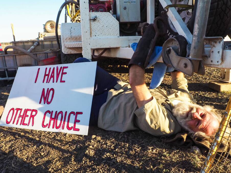 An image shared on Facebook by Frontline Action on Coal, showing Will Douglas protesting at an Adani coal mine. 