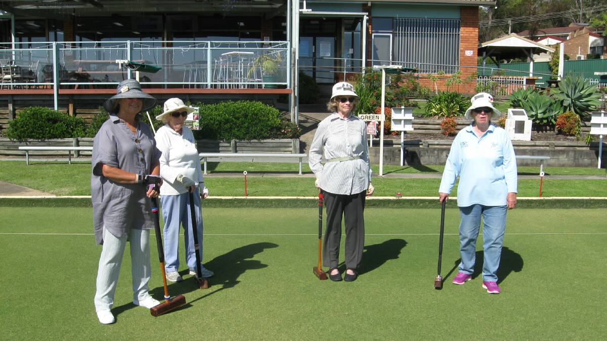 Croquet players from Cathy Sforcina, Pearl Hanson (team A), Louise Starkie and Helen Stannard (team B), in game 2 of golf croquet, wait their turn to tackle hoop 11.