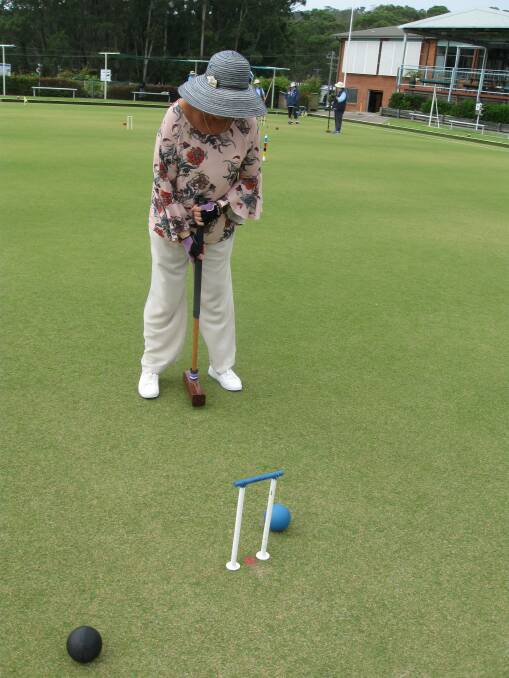 Cathy Sforcina plays the blue ball to hoop 1 in game 4 of golf croquet.