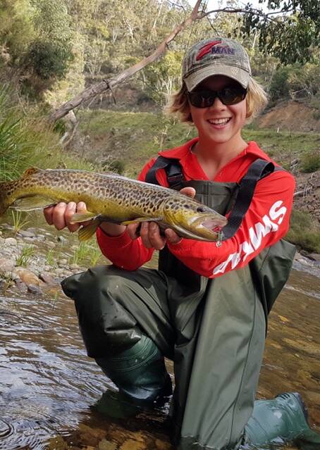 Beauty: Narooma Sport and Gamefishing Club junior member Sam Guy with a Brown Trout caught on a running freshwater stream down south.