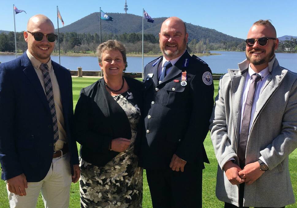 Glenn received his award accompanied by his family including wife Liz, and sons Joshua and Isaac. Image: Marine Rescue NSW.