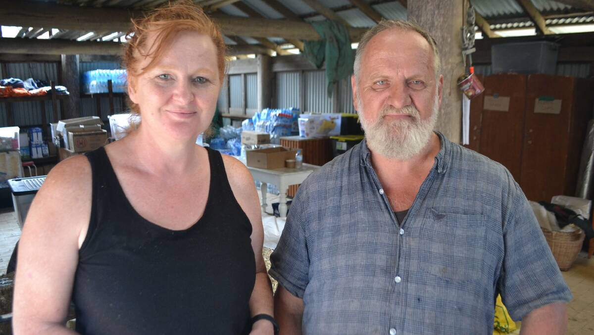 Deb and Ron Threlfall pleased to be able to move donated goods into the shipping container to create more space for the community in one of the remaining buildings. 