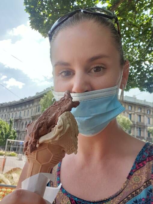 Raquel Brown's first outing post COVID in June, trying to eat gelato with a face mask. 