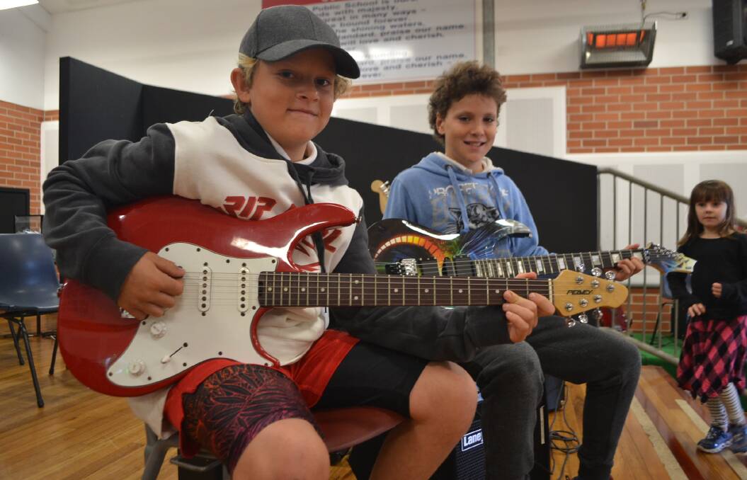 Shredders: Mitch Louden and Ozi White of the year five Sharks tear it up on electric guitars during rehearsals last week. 