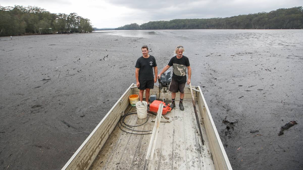 Tyron and Anthony Brice venture through the muck on the Tuross River to assess their oyster leases. Photos: Adam McLean 