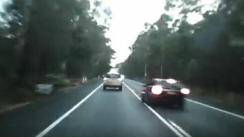 The driver of the black car veers onto the wrong side of the road to overtake Steve Knox, narrowly missing a head on collision with a northbound vehicle.