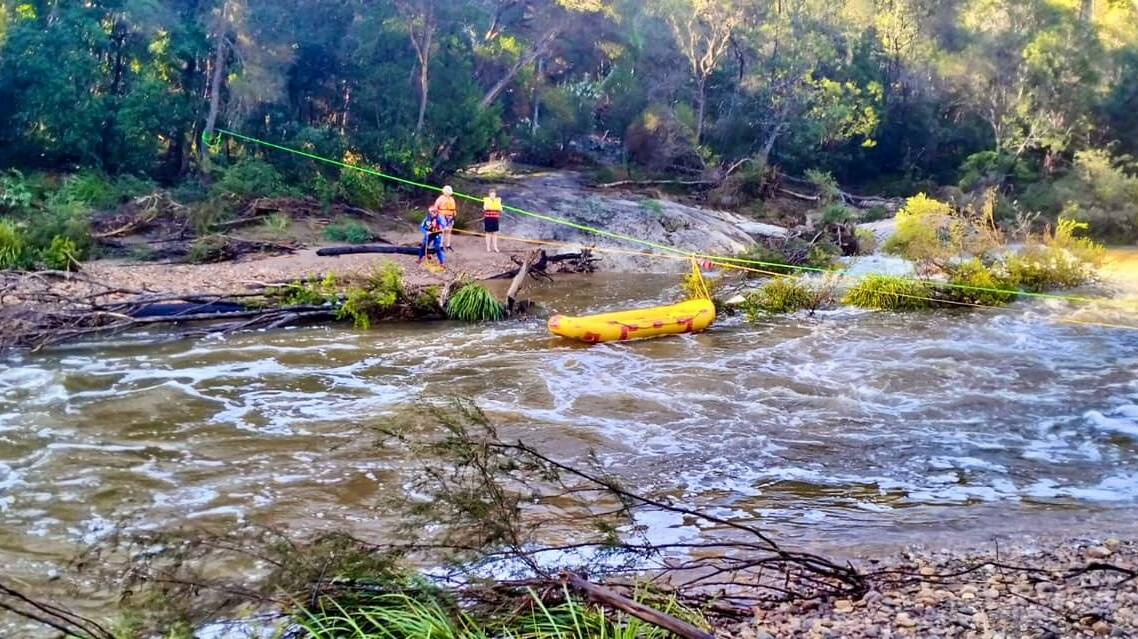 A Bega Valley SES volunteer with the stranded tourists, after cross the Yowaka River. Picture supplied