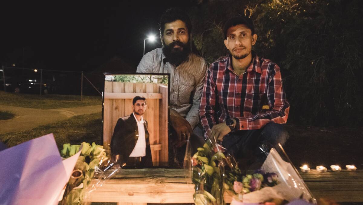 Zeeshan Akbar's friend Adnan Amjid and brother Faizan Akbar at the vigil to remember Zeeshan one year from his death. Photo: Jamila Toderas