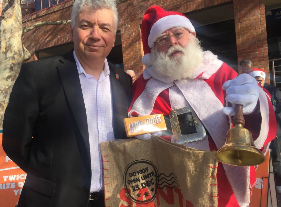South Coast Labour Council's Arthur Rorris and 'Santa' delivering gifts to Gilmore MP Ann Sudmalis to show displeasure at July wage changes.