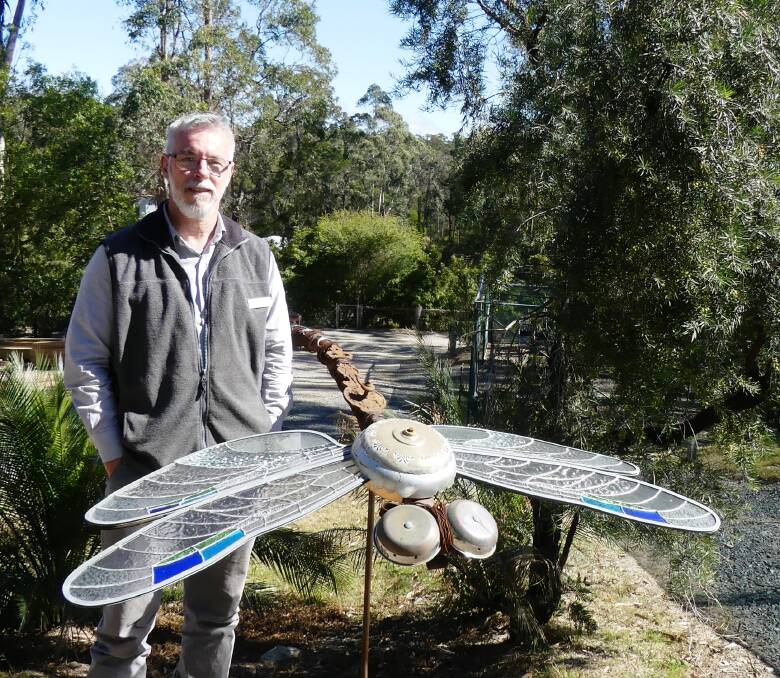 Eurobodalla Regional Botanic Gardens Manager Michael Anlezark with a sculpture installed as part of a previous exhibition at the facility. Now owned by the garden, the sculpture will display again for 'Up The Garden Path'.