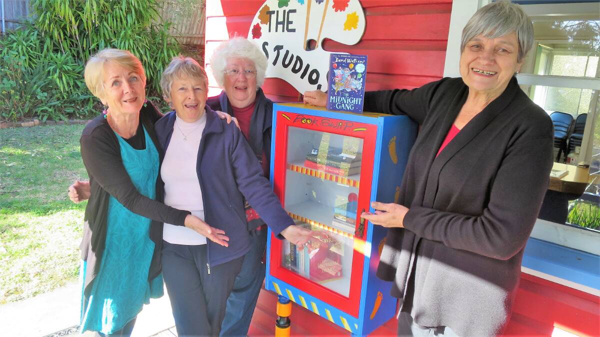 SWAPPING STORIES: Artists Suzanne Dainer, Marg Ingamells, Felicity Townend and Margaret Watson at their new School or Arts Studio book-nook.