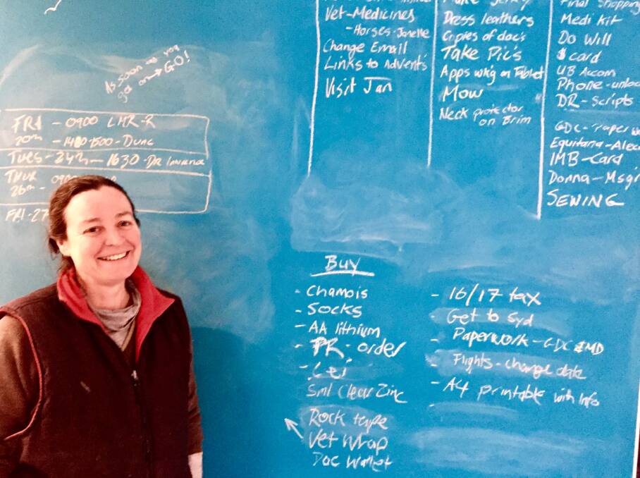 Cele Stone and the massive board she has installed at home to help plan her Mongolian adventure.
