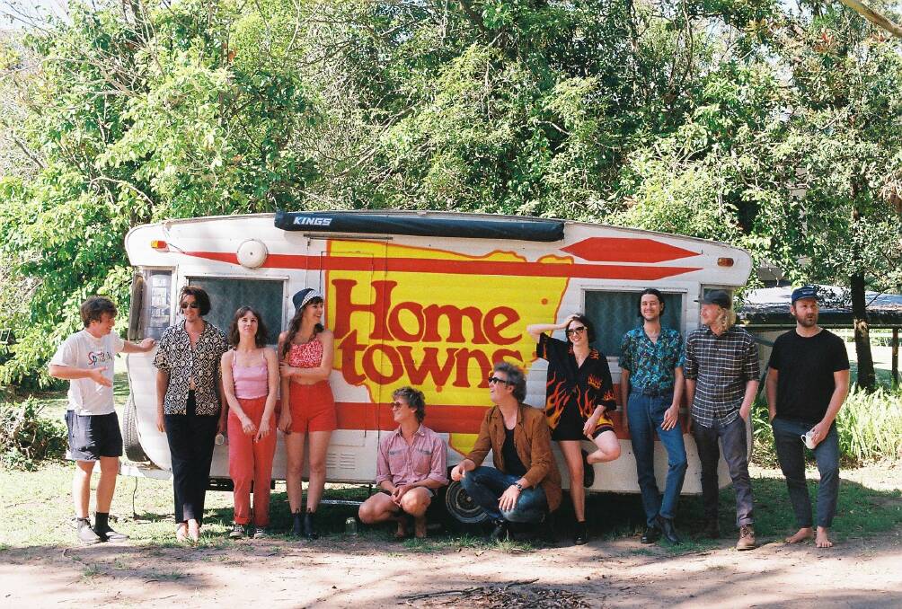 READY FOR THE ROAD: The bands and musicians combining forces for the Hometowns tour stop for a moment outside their tour's caravan. 