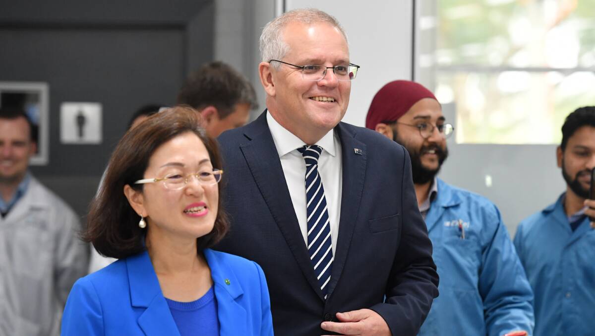 Liberal member for Chisholm Gladys Liu and Prime Minister Scott Morrison arrive at a press conference at Extel Technologies in Melbourne on Friday. Picture: AAP