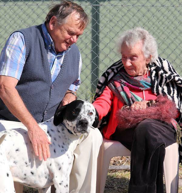 SPECIAL BOND: Marjory  Kember, 101, forms a special bond with Pat the dalmatian at Monty's Place last week. Pictured with musician Brian.
