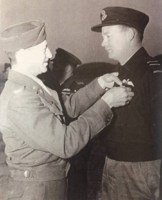 HONOURED: Fred Barnes decorated with the US Air Medal by Colonel Gray at Pusan, Korea.