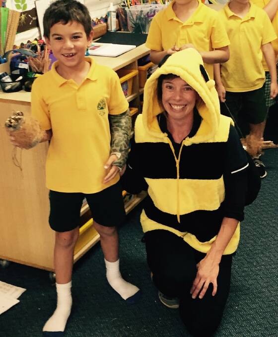 BUZZING: Ollie Martin and his peers at Sunshine Bay Public School were buzzing last month learning about bees. Pictured with Eurobodalla Council's Emma Patyus.