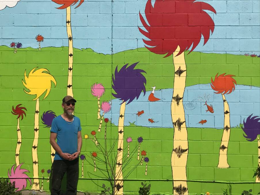 POP OF COLOUR: Artist Scott James has created a new attraction on the rear wall of Narooma Motors with his colourful Dr Seuss-inspired mural.