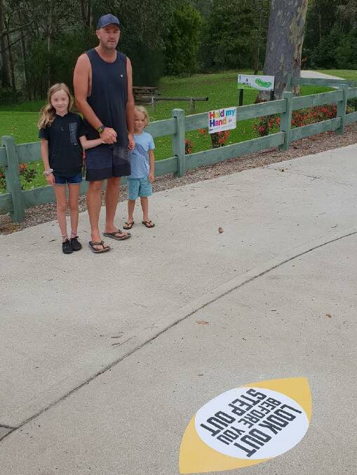 The Lee, Airlie and Cohen Price from Torquay Victoria with Narooma's new pedestrian safety stickers.