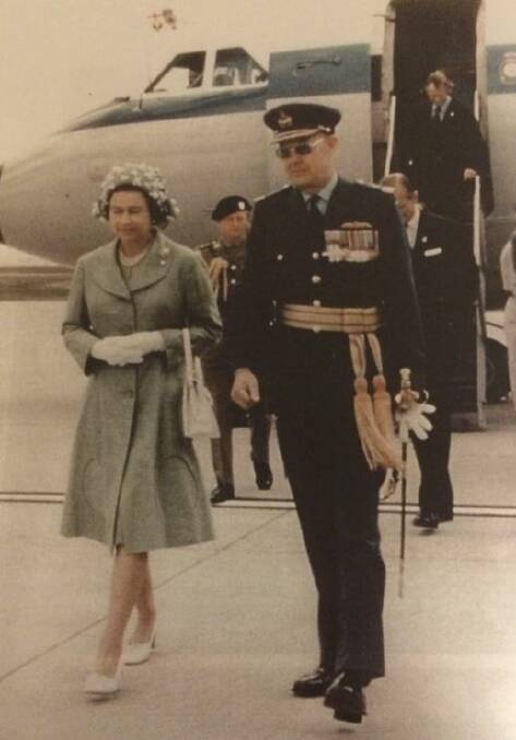 ROYAL DUTIES: Fred Barnes escorting the Queen on her arrival in Melbourne aboard RAAF VIP aircraft, in 1978.