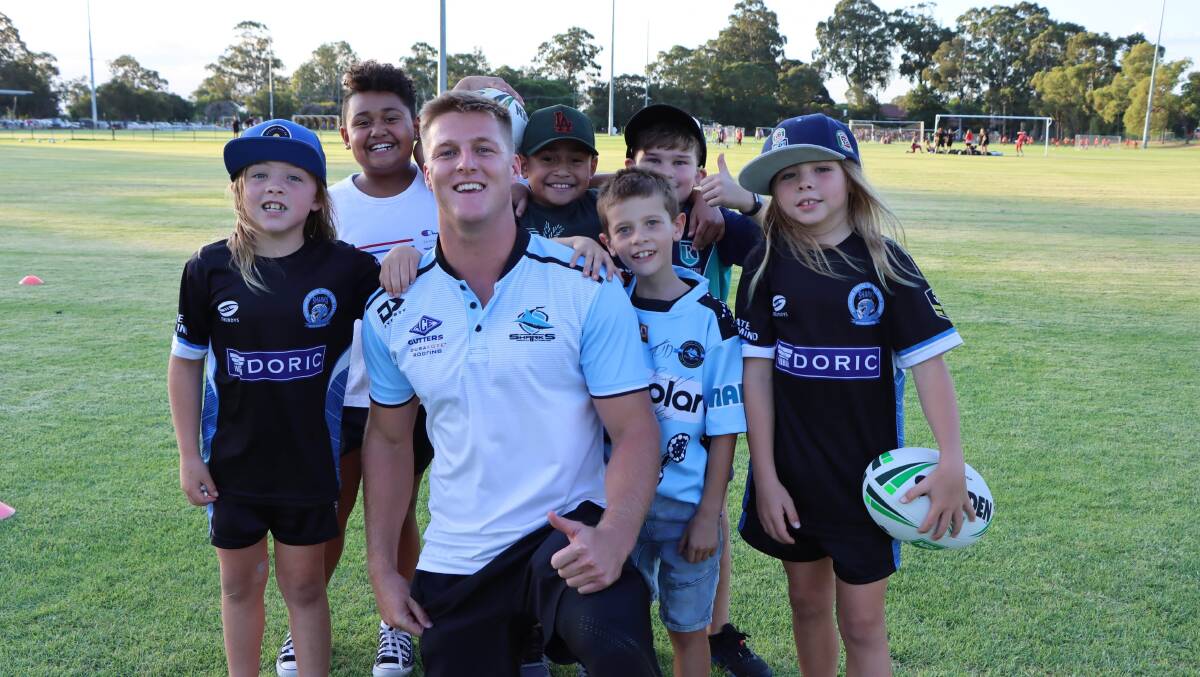 Fan favourite: Narooma's Teig Wilton catches up with some young fans as part of a skills clinic with the Cronulla-Sutherland Sharks. Picture: Sharks Media. 