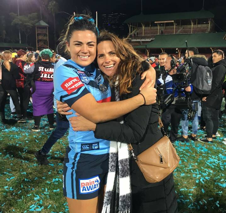 Cross code star: Millie Boyle shares a hug with her proud Mum Shelley Boyle following the Blues' 14-4 win over Queensland in front nearly 11,000 people on Friday. Picture: Facebook. 