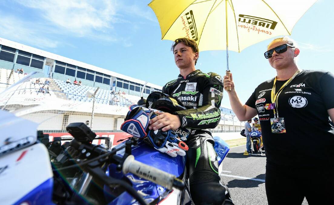 On course: Reid Battye on the grid with mum Renee during his wild card race in Jerez, with the 16-year-old now to race in Europe next year. Picture: Facebook. 