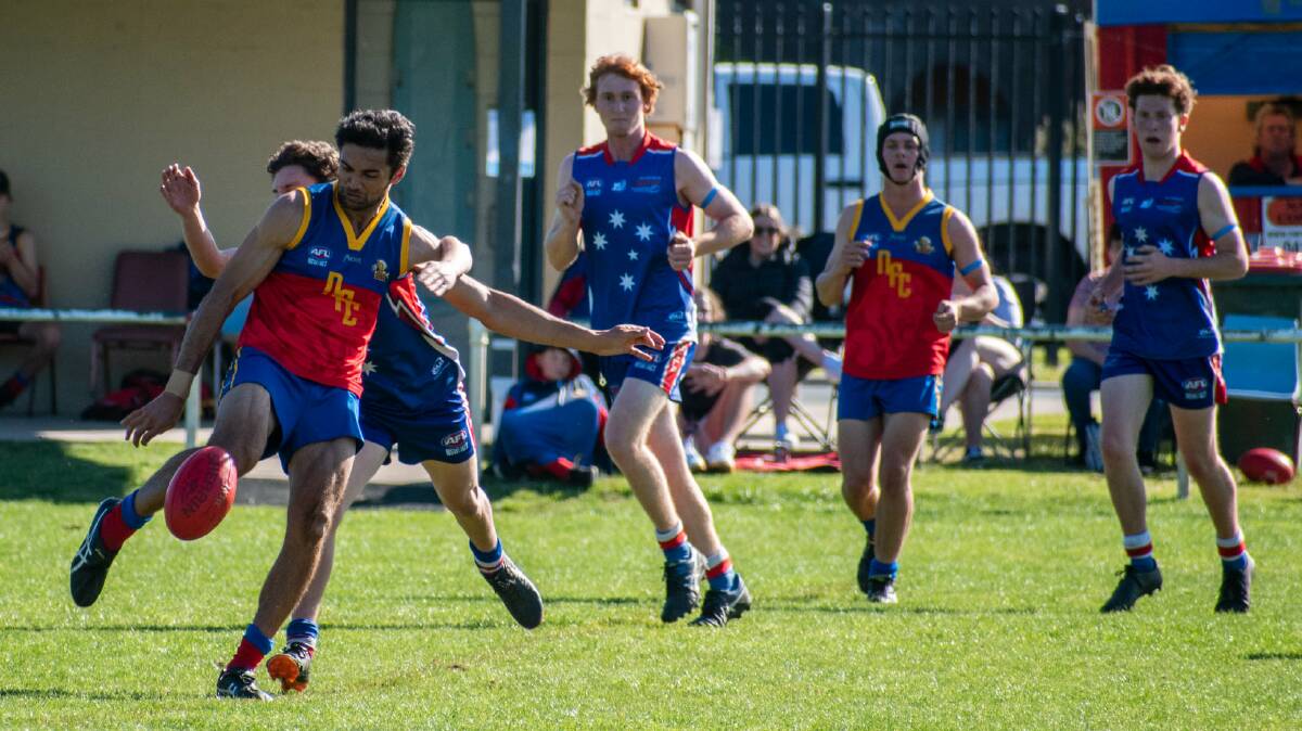 Minor premiers: Jason Sailuma gets a kick away from a tackle attempt as the Lions defeated Merimbula on Saturday to finish on top. Picture: Kim Harris. 