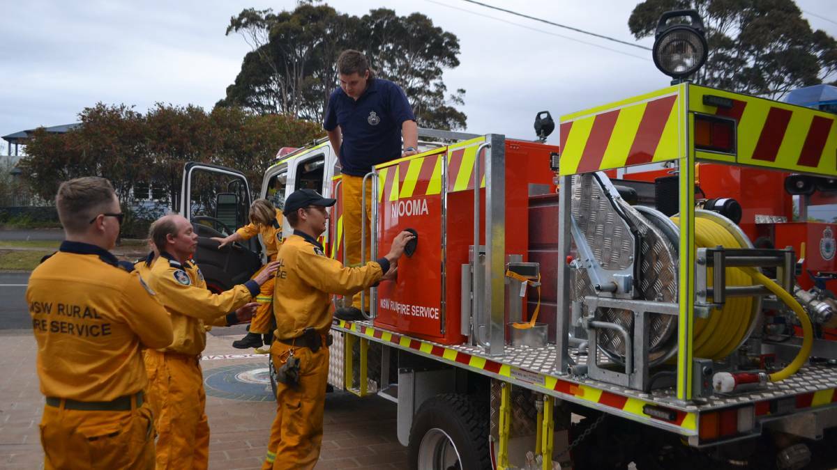 NEW TRUCK: The Narooma RFS brigade volunteers pictured with their new fire appliance responded to the house fire at Narooma on Sunday morning. File photo