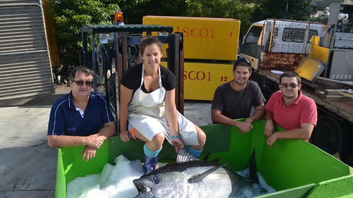 CATCH OF DAY: Hayley Abbott with her father John and brothers Todd and Ryan Abbott and a nice 70kg bigeye tuna. File photo 