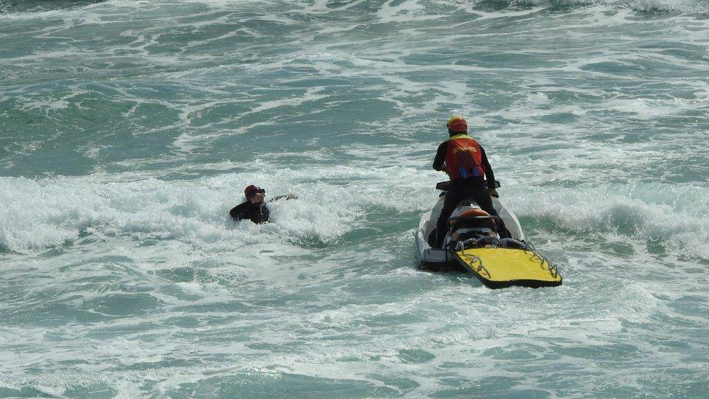 SURF SEARCH: Surf life savers search for the missing woman off Coila beach on Thursday. Photo by Max Castle. 