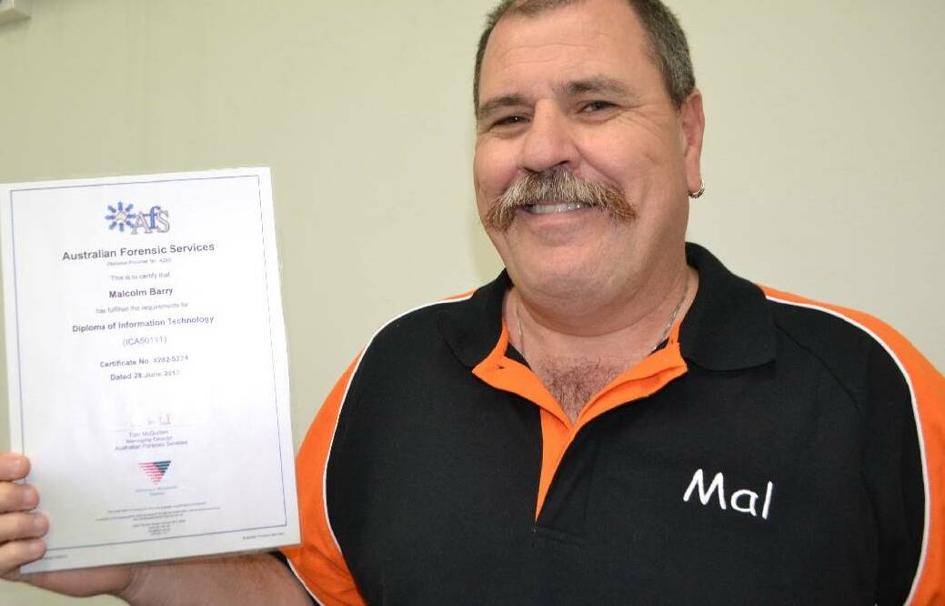 IT REPAIRS: Narooma’s Mal Barry, pictured with his Diploma of Information Technology, has been busy repairing people's computers. 