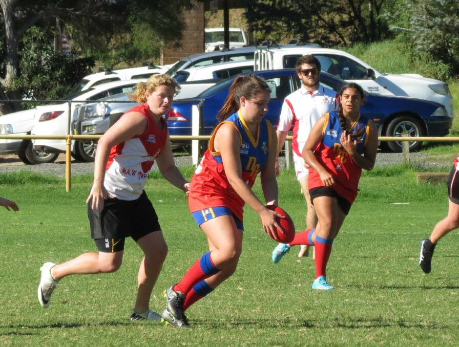 Narooma Lions AFL Women’s Football continued their improvement this week – Pictured are ladies players Keely Clark with the ball and Chenoa Lyons Mongta behind in their match against the Whalers. 