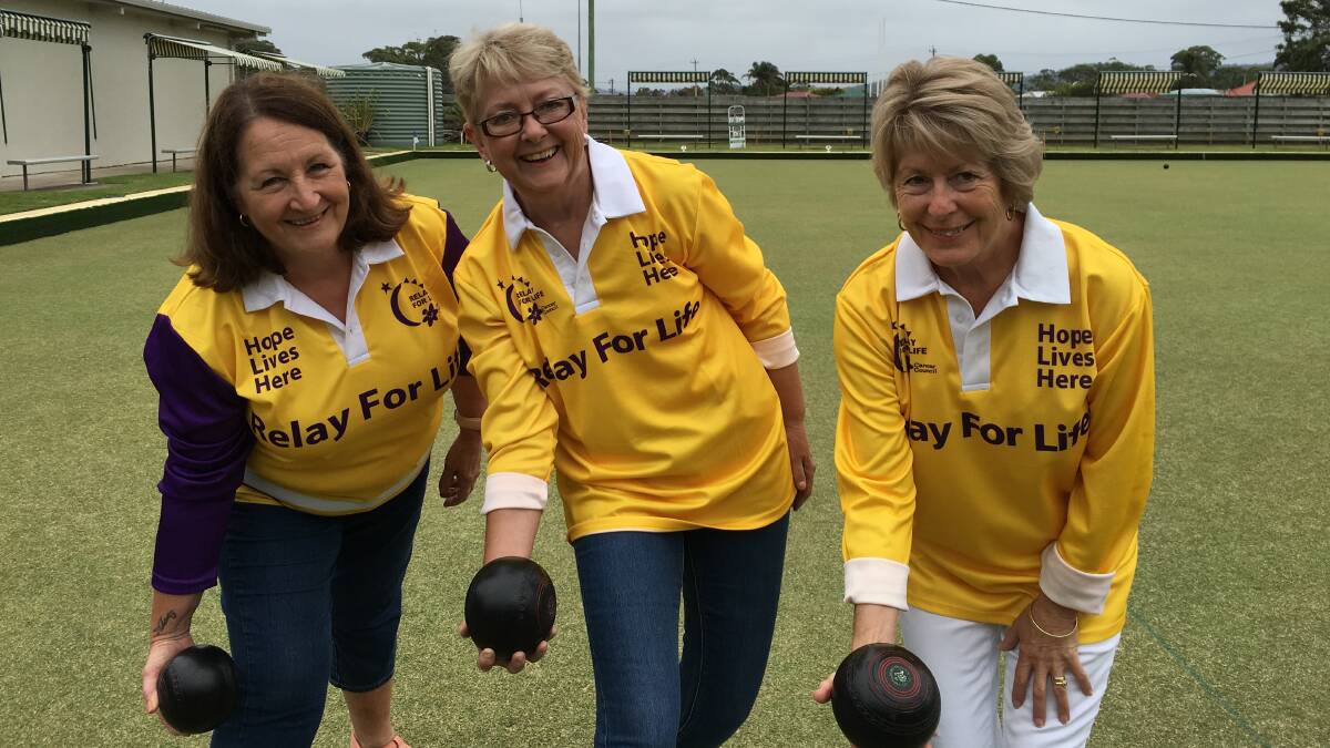 Bearing all below the knees for cancer are catering committee members Di Reid, Jane Rowley and Christine Williams kick up their heels to warm up for the barefoot bowls challenge on Friday, February 3.