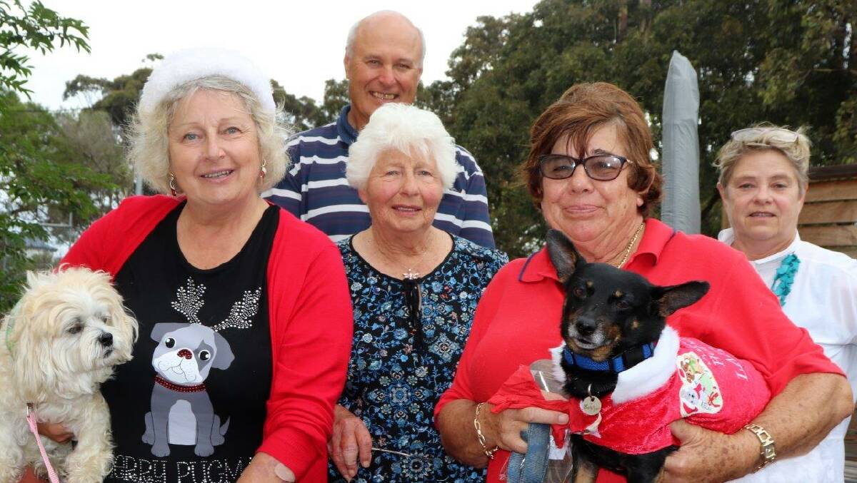 SEASONS GREETINGS: Narooma Dog Training Club instructors Jean Page, Yve Robinson and Carol Low with, back, trophy winners Peter Nelipa and Amanda Doust.  
