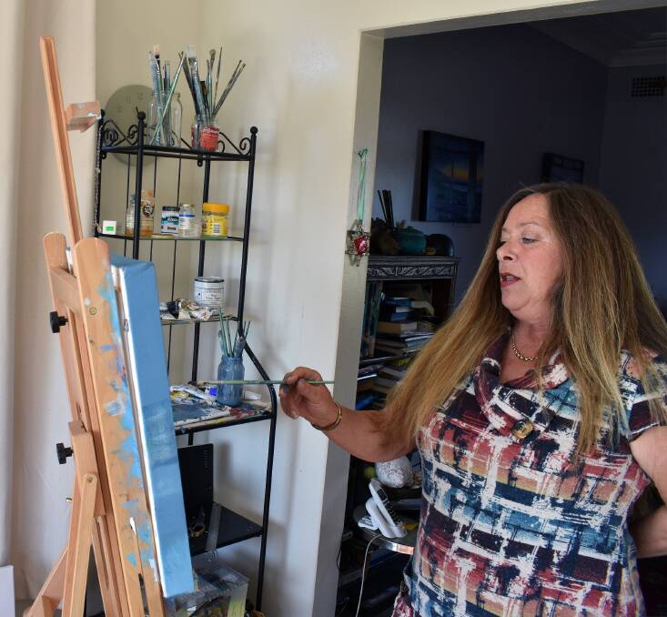 ART ENTRY: Pictured at her easel finishing her entry for the "Harbour" exhibition is Lyndal Jenkins, one of the Far South Coast’s successful visual artists. 