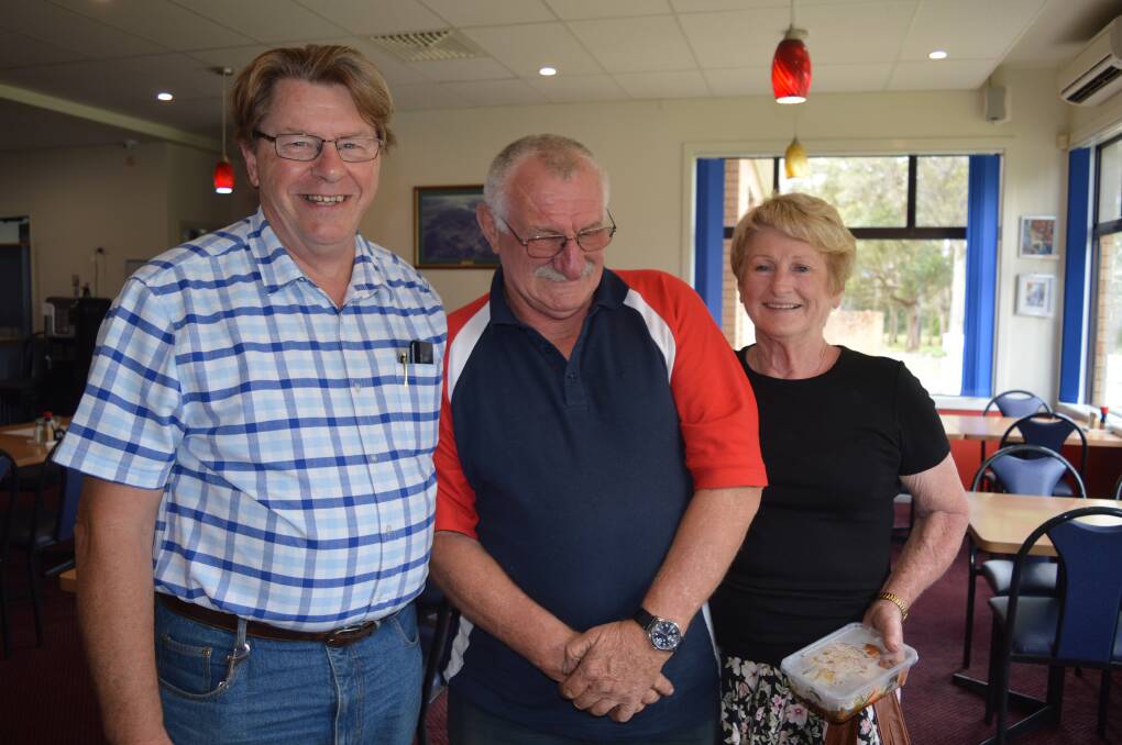 Moruya's Steve Mawson spreads Christmas cheer with Ian and Helen Browne at Saturdays get together for fire affected people in and around Bodalla.