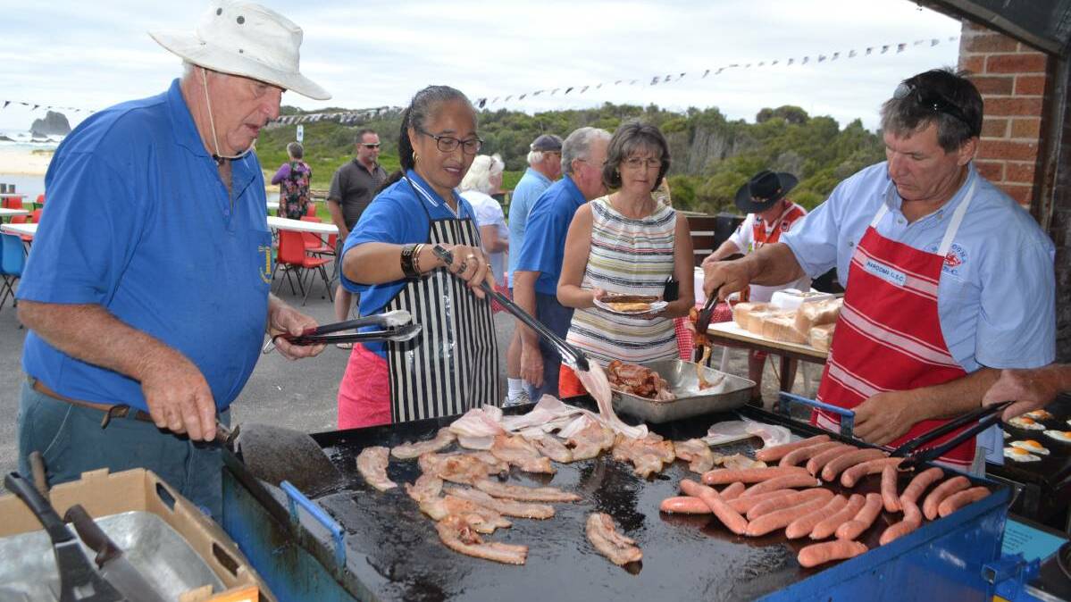Cooking up a great Australia Day barbecue breakfast on Narooma's Main Beach by Narooma Surf Lifesaving Club volunteers.