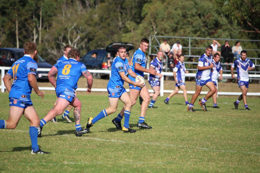 Bombala's Michael Wykes, Adam Rodwell (number 8), Andrew Guthrie with the ball, backed up by Luke Ingram.