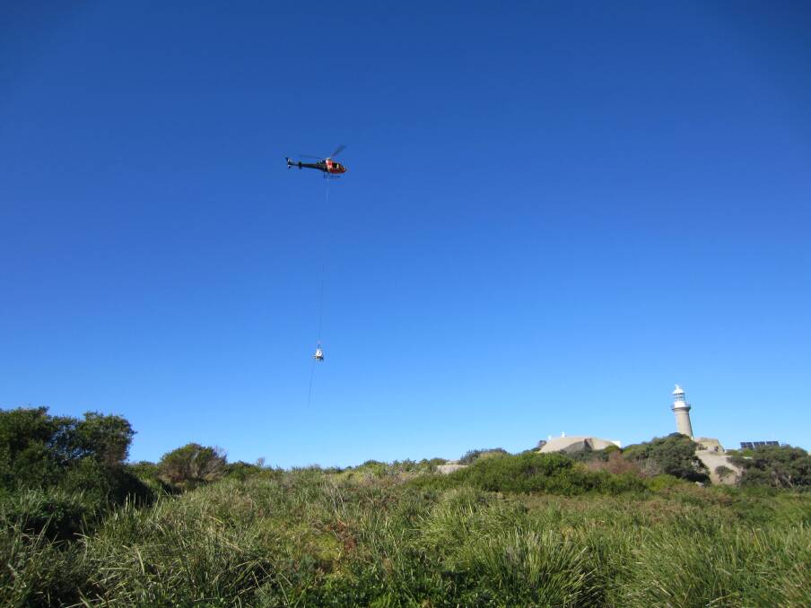 A helicopter brings materials to Montague Island for their annual spring spruce up.