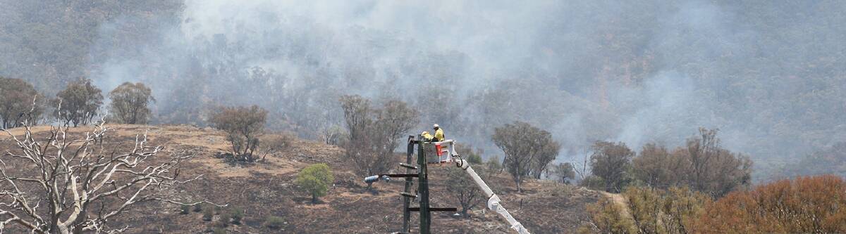 Essential Energy workers working hard to restore electricity to bushfire affected areas.