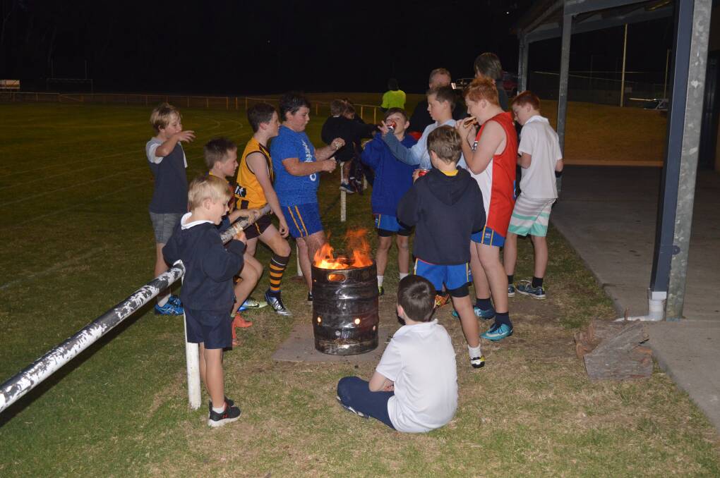 No clubhouse at Bill Smyth Oval, in Narooma, means training teams have to huddle around an open fire to keep warm in winter.
