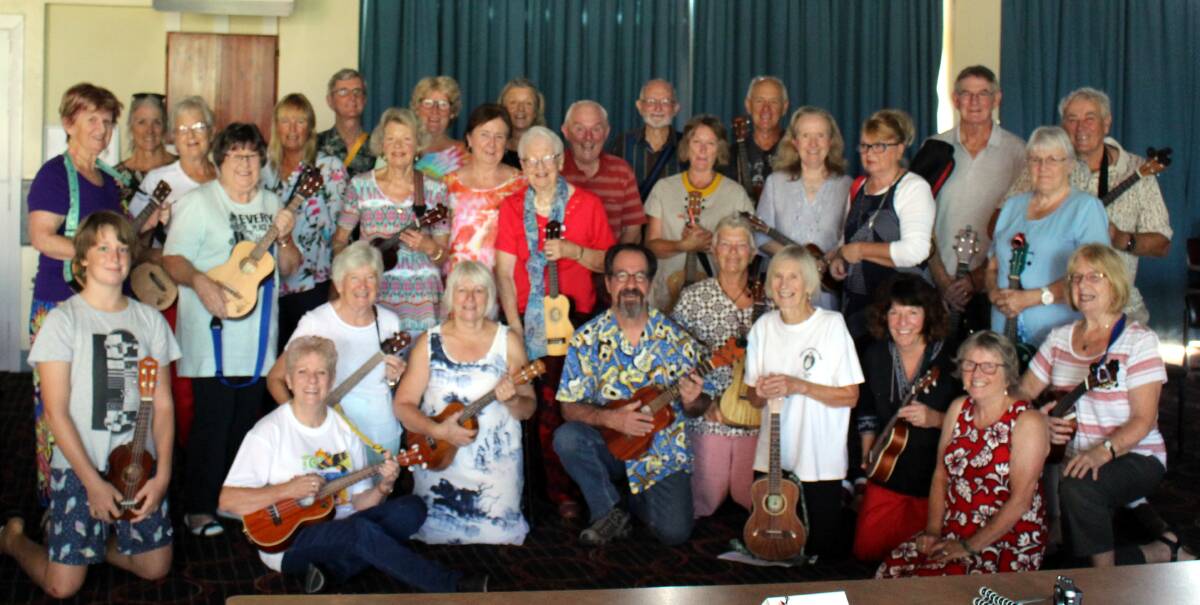 Michael Rosenberg, centre front with the ukulele players that attended his Blues Uke Workshop on Sunday morning before the main concert at Bermagui Country Club.
