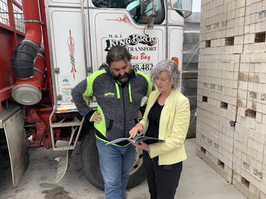 Eurobodalla Council's economic development and place activation manager Teresa Lever shows council's latest business survey to Brett MacAlpine from King Bros Transport.