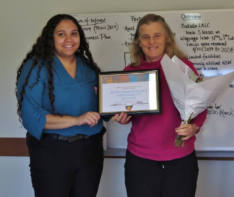 SUNNY OUTCOME: Nakia Moreton-Stewart presents Kathryn Maxwell of SHASA a bouquet of flowers and a certificate in appreciation for the solar system donated to the Bodalla LALC. 