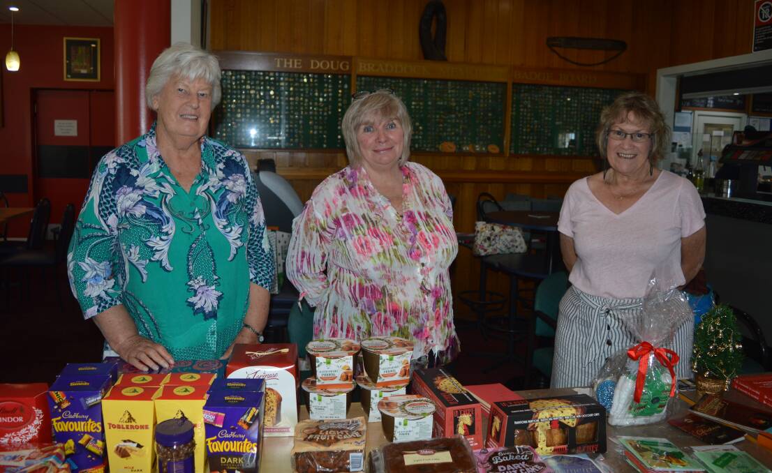 Bev Davis, Jill Mawson and Sandra Ortega with goodies for fire affected families at a pre-Christmas luncheon in Bodalla on Saturday.