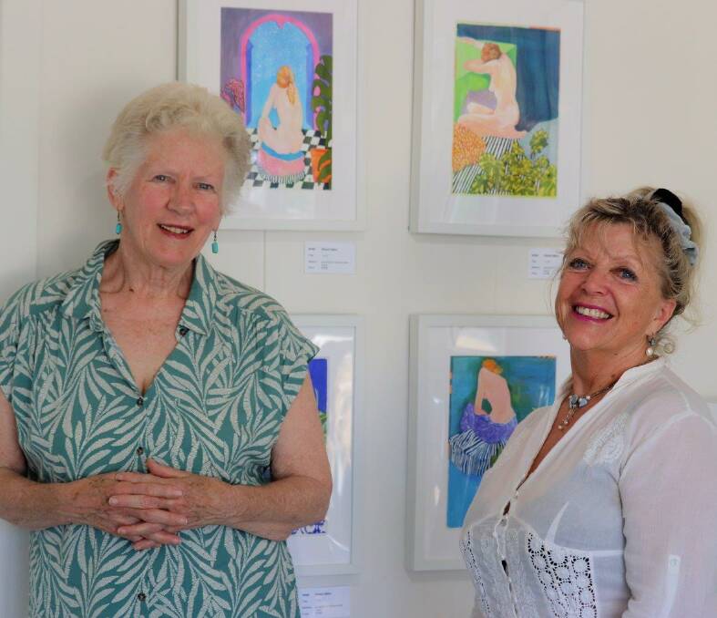 Artists Janet Jones, left and Lesley Lambert at "The Art of Body Language Exhibition", admiring works by Cheryl Djikic and other MACS artists on at the SoART Gallery, Narooma.