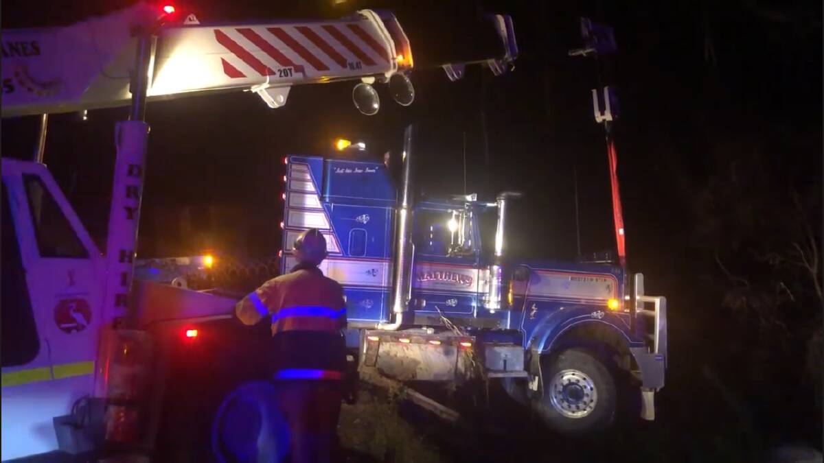 Lucky escape for truck driver suspended over creek on Princes Hwy